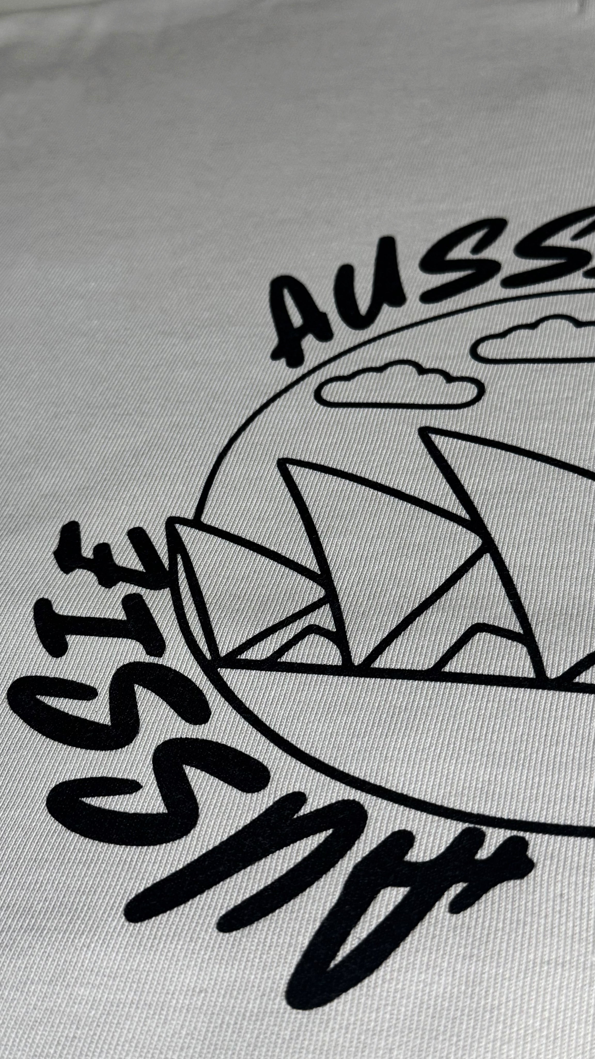 Gray fabric with black 'Aussie' text and Sydney Opera House design.