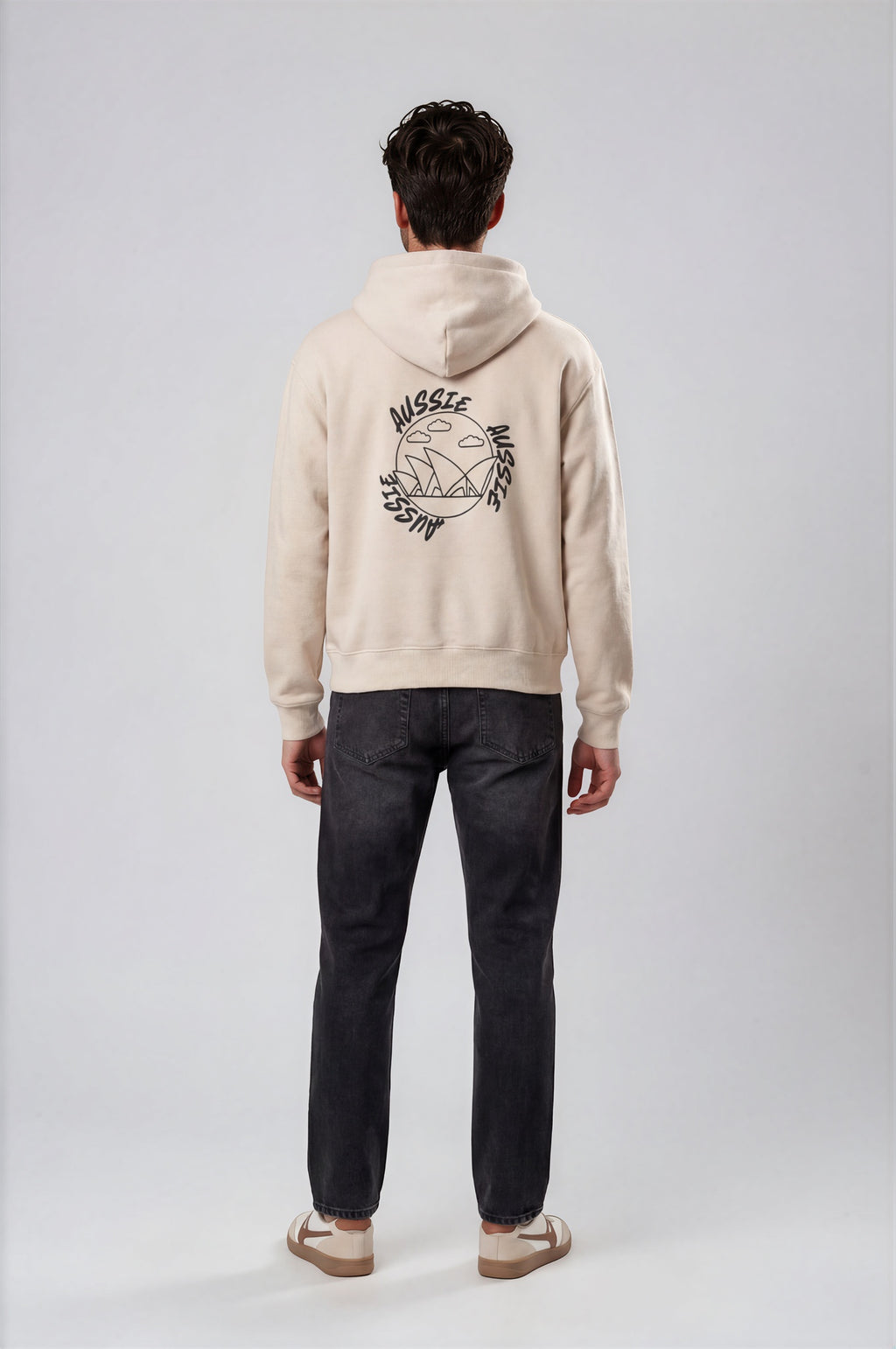Person wearing a beige hoodie with a logo on the back against a white background
Man wearing a beige oversized hoodie with 'mvbe' logo against a plain background. ribbed sleeves and hem. warm oversized hoodie, these are uni-sex unisex products. The hoodie has aussie, aussie, aussie logo. logo says aussie aussie aussie. australian aussie hoodie