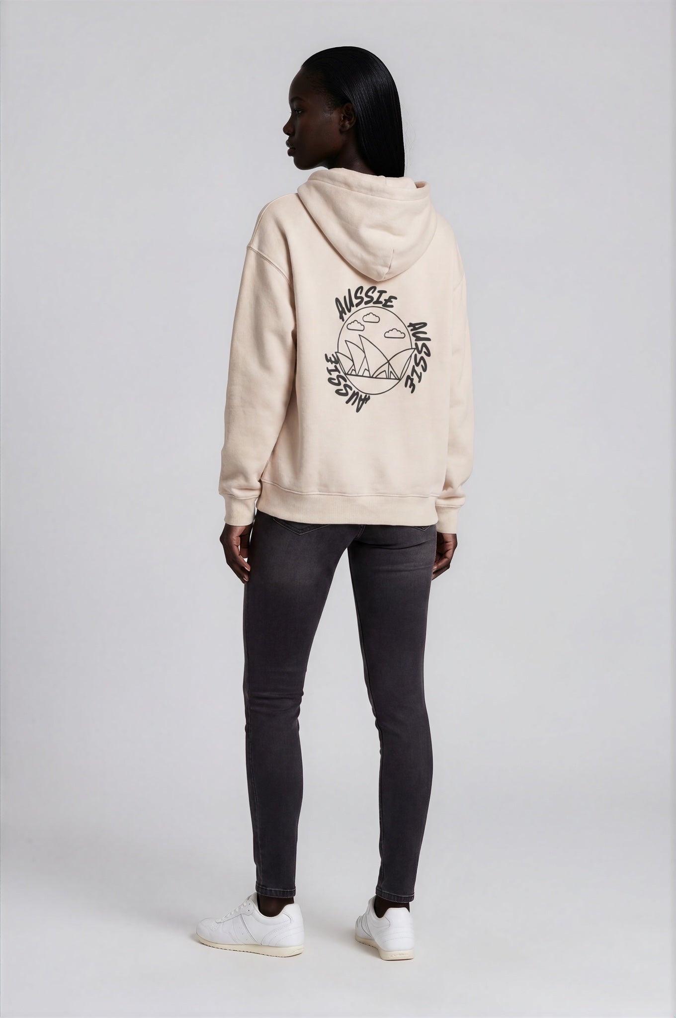 Person wearing a beige hoodie with a logo on the back against a white background
Man wearing a beige oversized hoodie with 'mvbe' logo against a plain background. ribbed sleeves and hem. warm oversized hoodie, these are uni-sex unisex products. The hoodie has aussie, aussie, aussie logo. logo says aussie aussie aussie. australian aussie hoodie