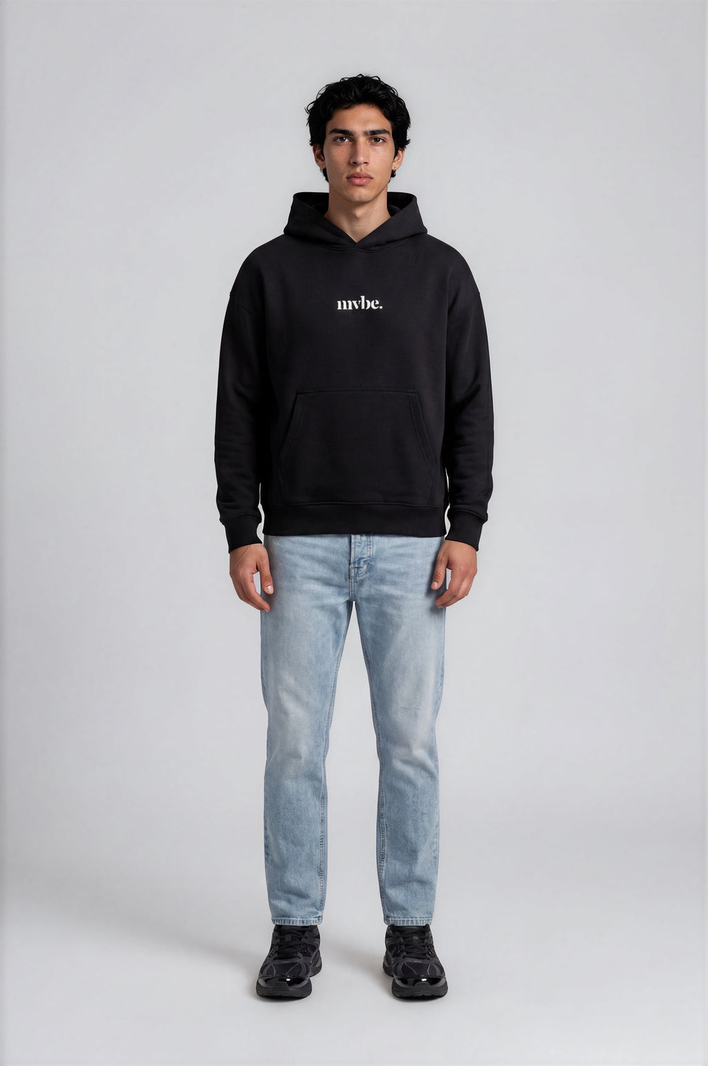 Person wearing a black hoodie with a design pattern on the back against a white background
Man wearing a black oversized hoodie with 'mvbe' logo against a plain background. ribbed sleeves and hem. warm oversized hoodie, these are uni-sex unisex products. The hoodie has pakistani design on the back. it  says shayad in urdu on a hoodie. hoodie is having rug design. pakistani origin.
