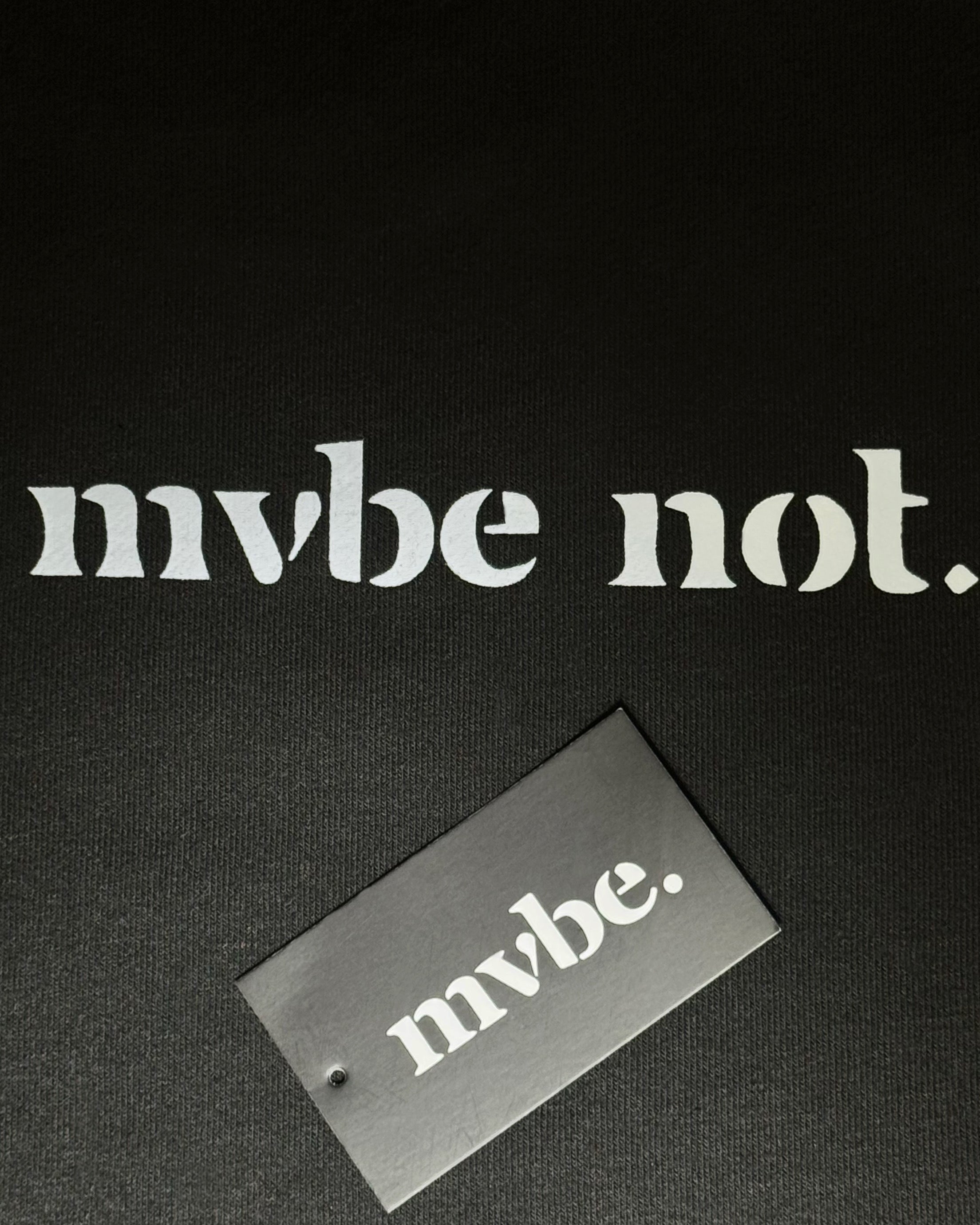 Person wearing a black sweatshirt with a design pattern on the back against a white background
Man wearing a black oversized sweatshirt with 'mvbe' logo against a plain background. ribbed neck, sleeves and hem. warm oversized hoodie, these are uni-sex unisex products. the design at back says mvbe, mvbe not. which is a signature sweatshirt for the brand. it is comfortable and a soft material sweat.
