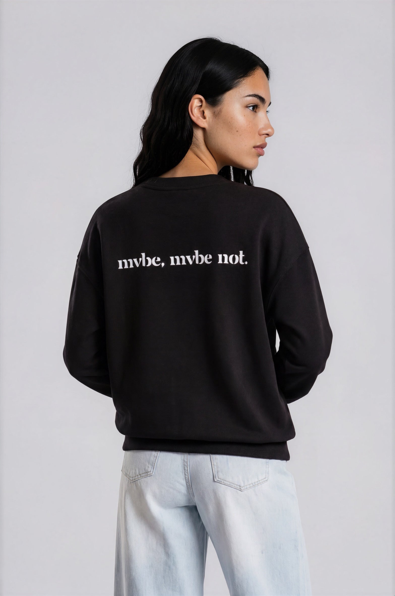 Person wearing a black sweatshirt with a design pattern on the back against a white background
Man wearing a black oversized sweatshirt with 'mvbe' logo against a plain background. ribbed neck, sleeves and hem. warm oversized hoodie, these are uni-sex unisex products. the design at back says mvbe, mvbe not. which is a signature sweatshirt for the brand. it is comfortable and a soft material sweat.
