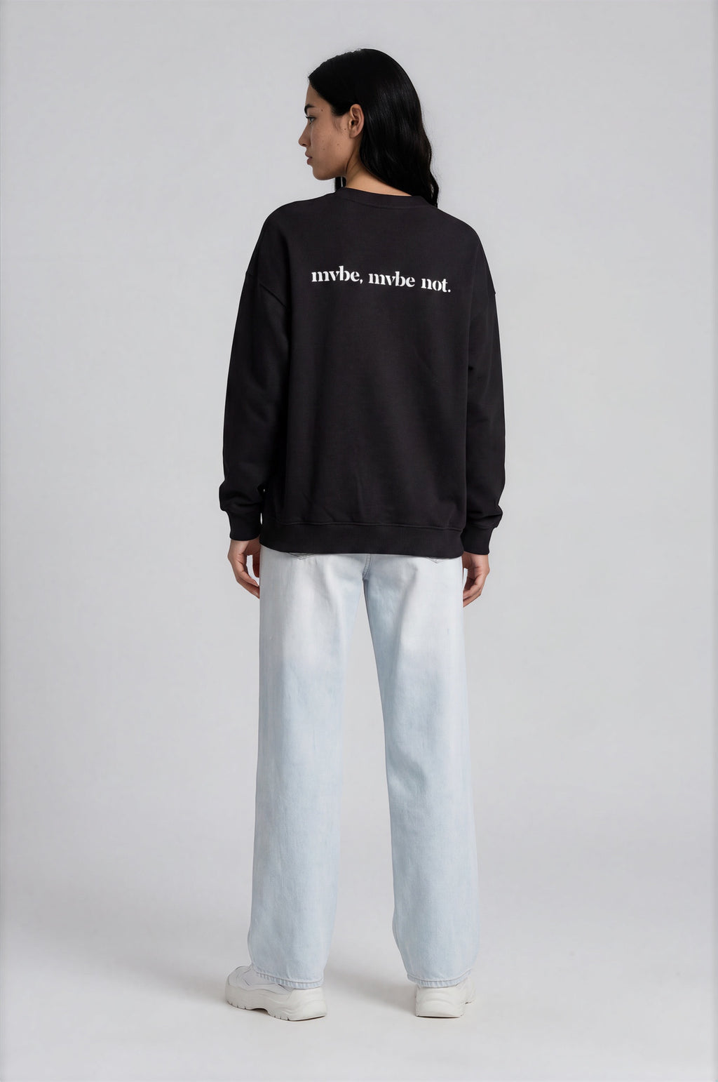 Person wearing a black sweatshirt with a design pattern on the back against a white background
Man wearing a black oversized sweatshirt with 'mvbe' logo against a plain background. ribbed neck, sleeves and hem. warm oversized hoodie, these are uni-sex unisex products. the design at back says mvbe, mvbe not. which is a signature sweatshirt for the brand. it is comfortable and a soft material sweat.
