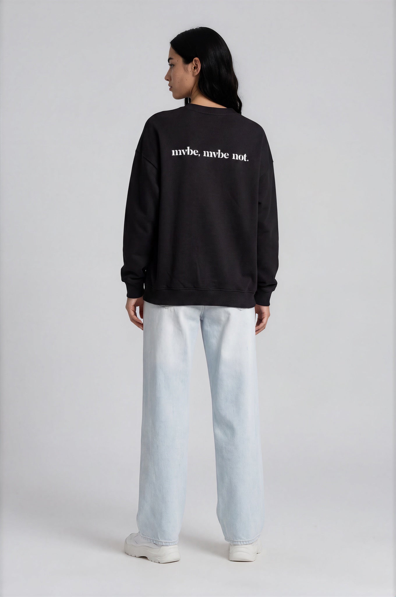 Person wearing a black sweatshirt with a design pattern on the back against a white background
Man wearing a black oversized sweatshirt with 'mvbe' logo against a plain background. ribbed neck, sleeves and hem. warm oversized hoodie, these are uni-sex unisex products. the design at back says mvbe, mvbe not. which is a signature sweatshirt for the brand. it is comfortable and a soft material sweat.