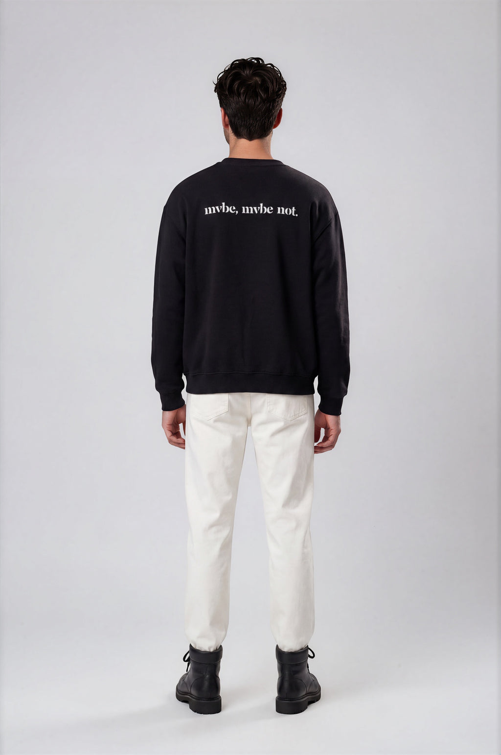 Person wearing a black sweatshirt with a design pattern on the back against a white background
Man wearing a black oversized sweatshirt with 'mvbe' logo against a plain background. ribbed neck, sleeves and hem. warm oversized hoodie, these are uni-sex unisex products. the design at back says mvbe, mvbe not. which is a signature sweatshirt for the brand. it is comfortable and a soft material sweat.